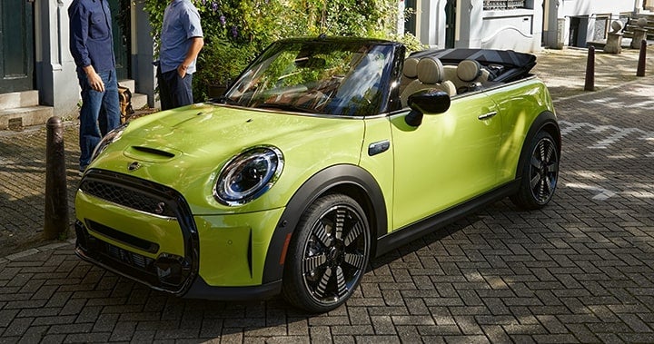 A side view of the MINI Convertible parked downtown.