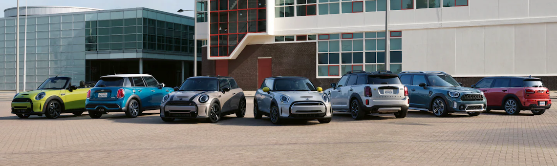 MINI Cooper vehicles parked outside of a building