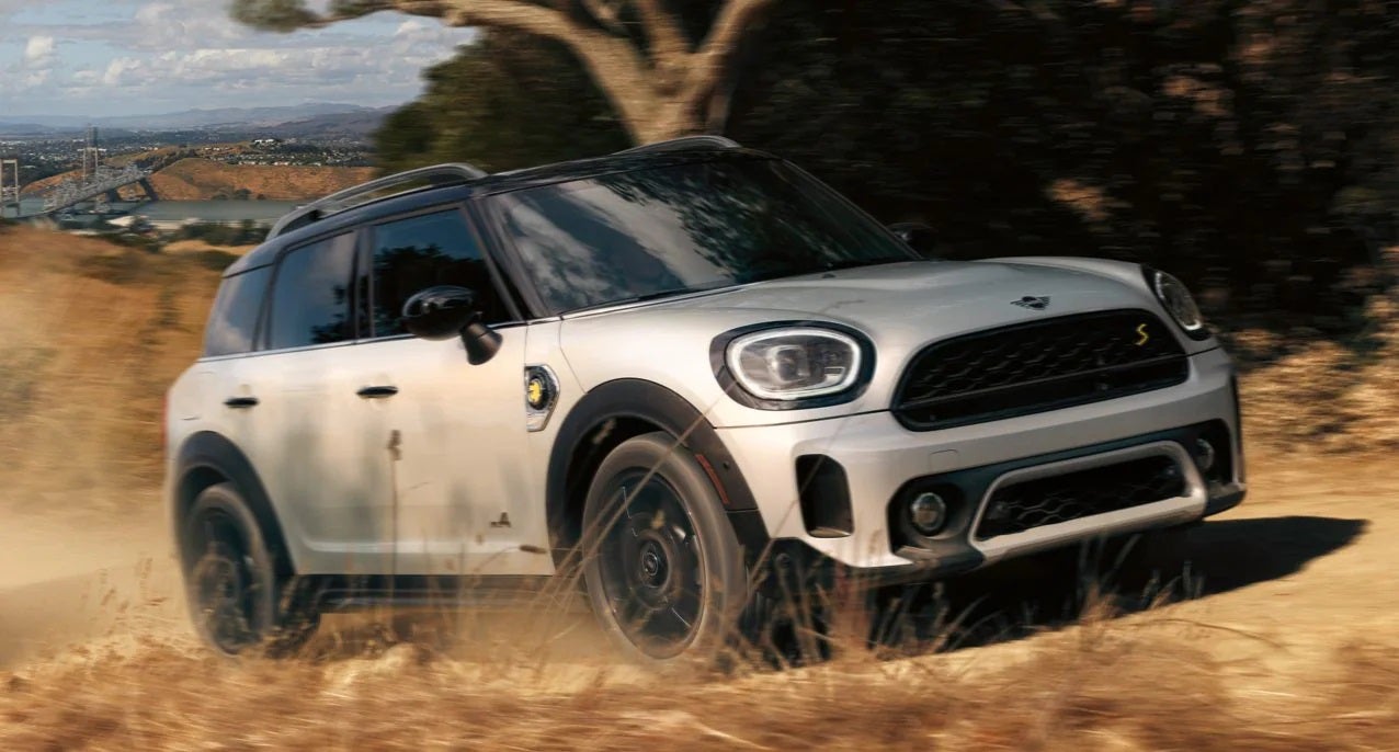 The MINI Cooper SE Countryman PHEV driving on dirt terrain. MINI of Sterling in Sterling VA