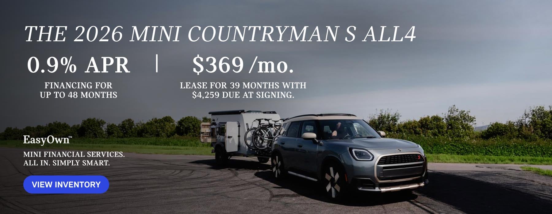 Grey MINI Countryman parked with bicycles and trailer in tow.
