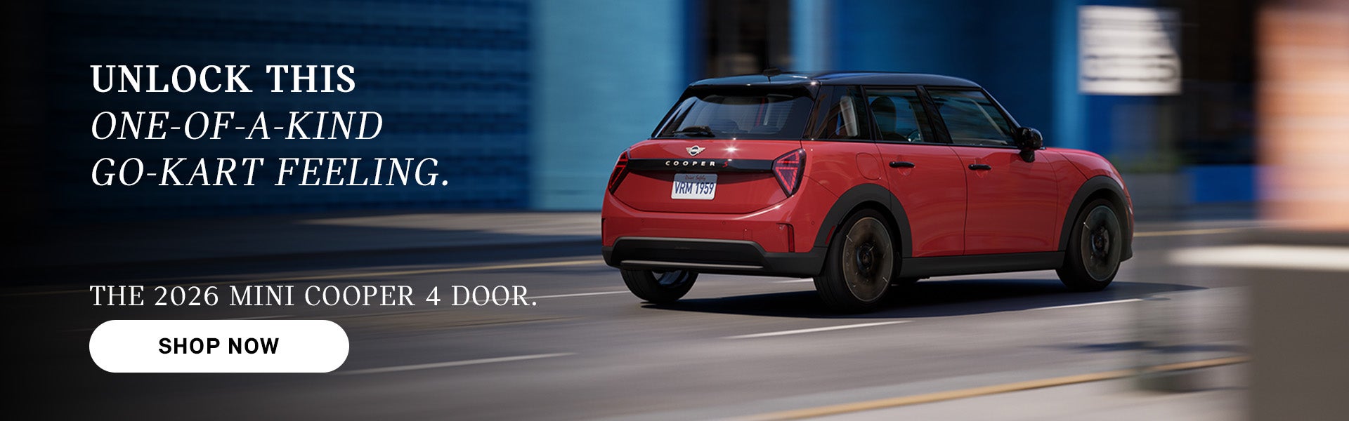 Red MINI Cooper 4-door driving on a city street, with motion blur in the background and ad text promoting the 2026 model and 