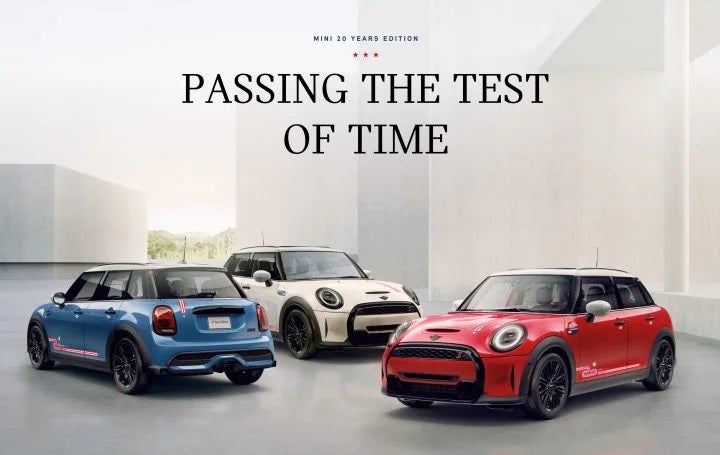 hree MINI 20 Years Edition cars in blue, white, and red, parked side-by-side on a grey surface with white square buildings in the background. | MINI of Sterling in Sterling VA