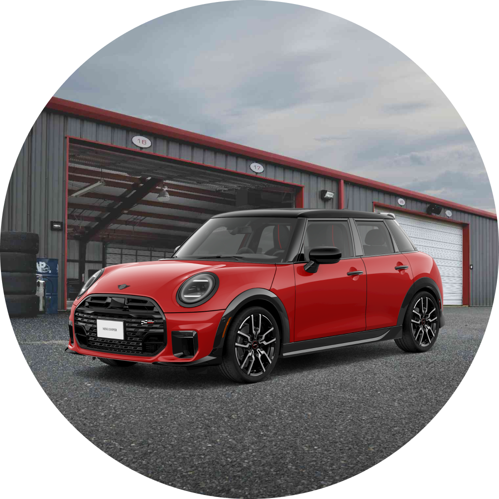 Angled-view of a MINI Cooper 4 Door parked in front of an industrial garage.