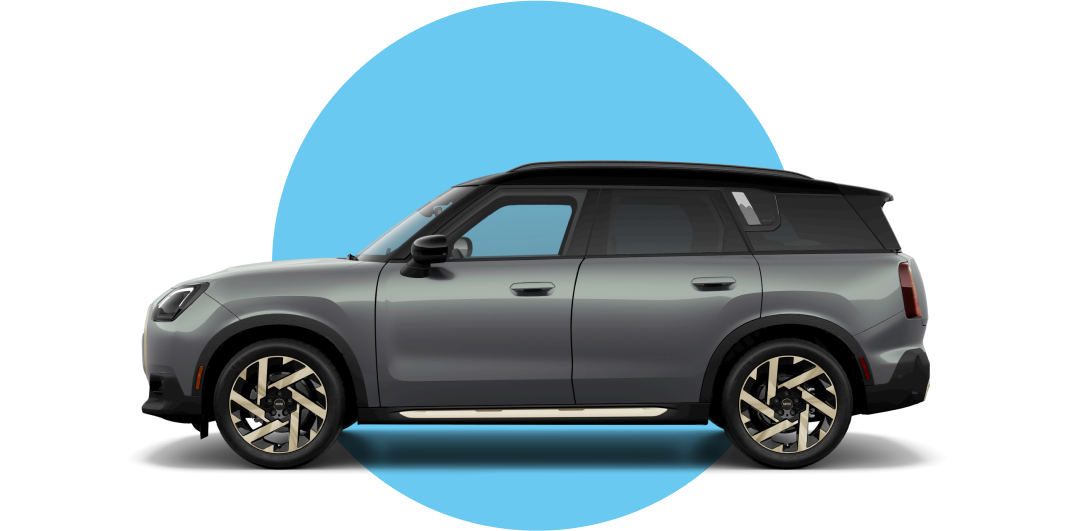 Side view of a 2025 MINI Countryman SE ALL4 in the Smokey Green body color, facing left with its shadow underneath it