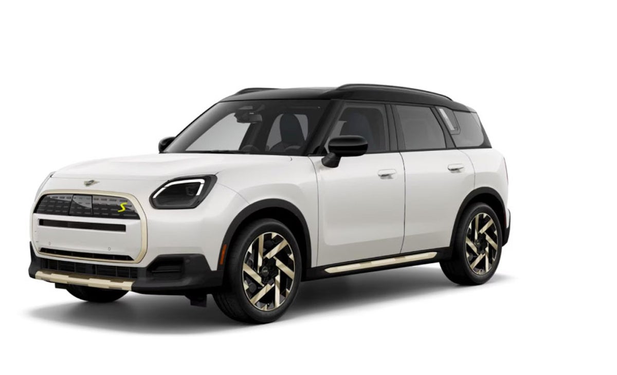 Angled view of a white MINI Countryman SE ALL4 vehicle parked.