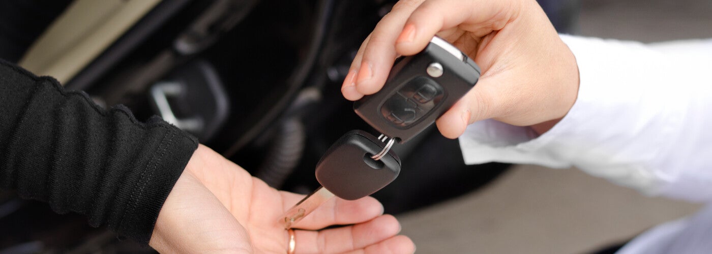 car dealer handing over keys