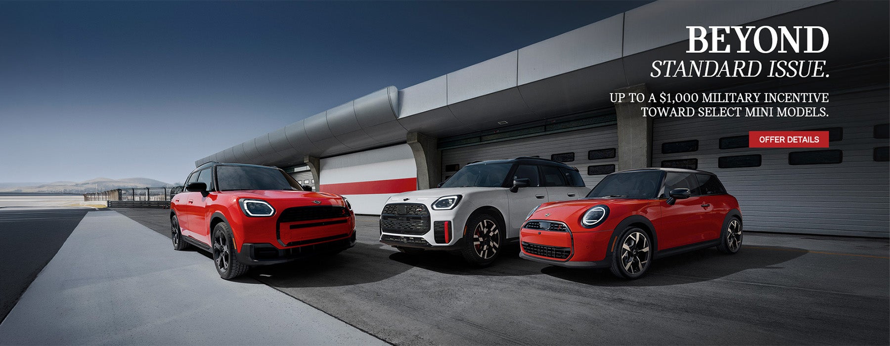 Three MINI's parked in front of a plane hanger.